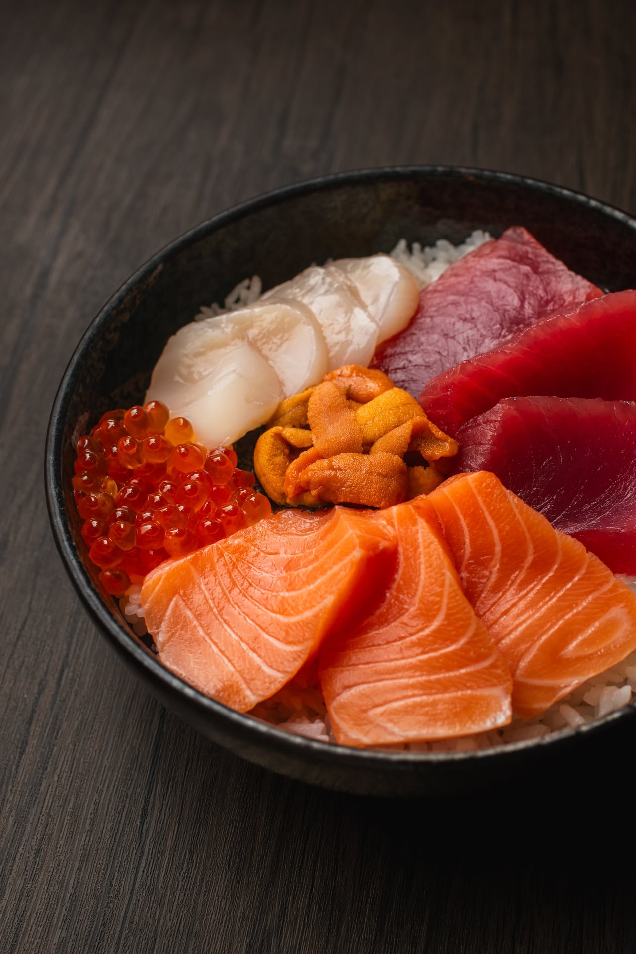 A sashimi bowl with salmon, ahi, scallop, uni and ikura